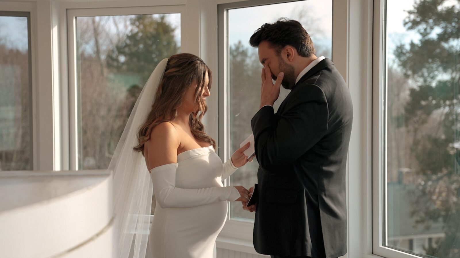 Still frame of a bride and groom exchanging private vows at the top of the lighthouse at Lighthouse Bluff Airbnb in Fennville, Michigan for their Lake Michigan Airbnb wedding.