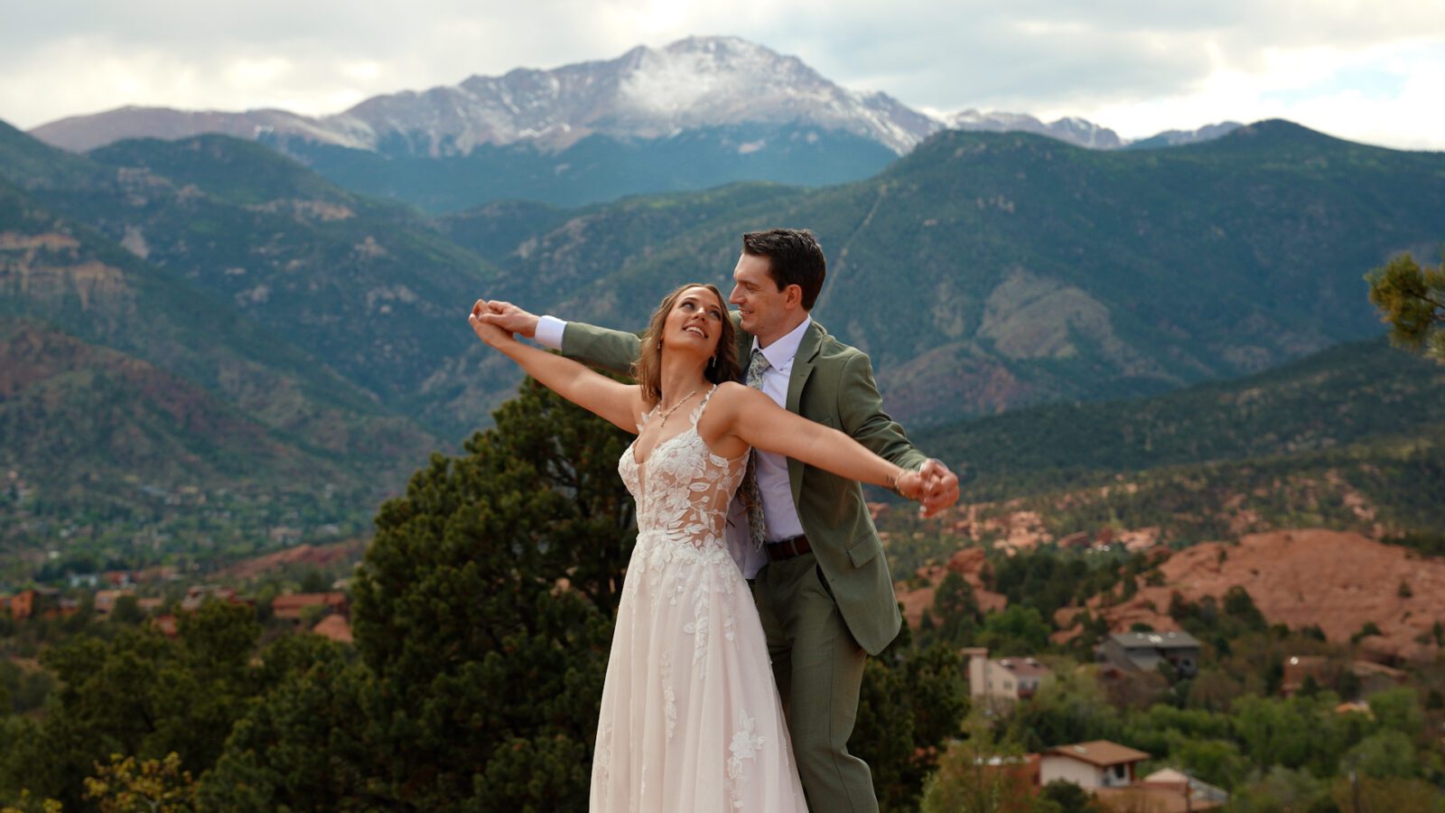 Couple holding hands with mountain views during their Garden of the Gods wedding portraits.